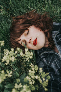 Young woman lying down on field