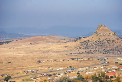 High angle view of land and mountains against sky