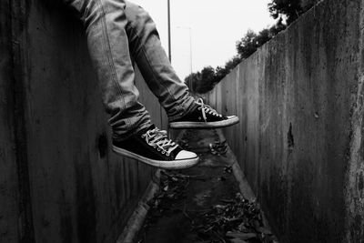 Low section of person standing on wall