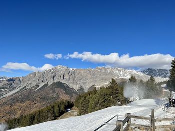 Scenic view of snowcapped mountains against clear blue sky