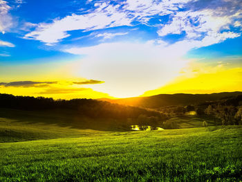 Scenic view of field against dramatic sky