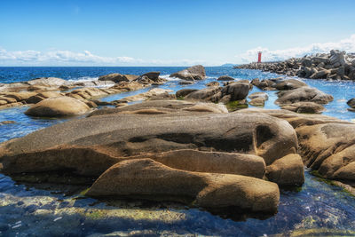 Rocks on beach against sky
