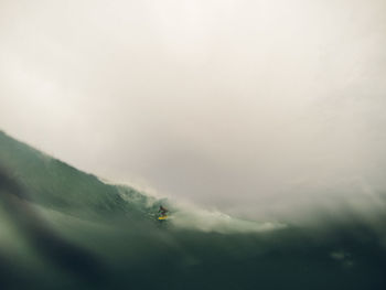 Waves flowing at sea against sky