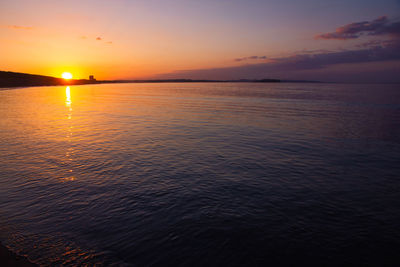 Scenic view of sea against romantic sky at sunset