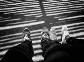 Low section of man and woman standing on walkway