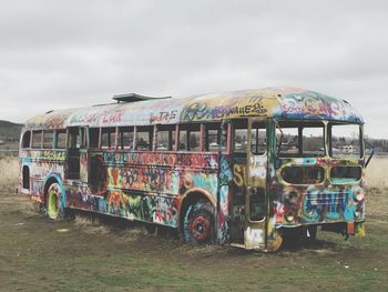 Abandoned truck on field against sky