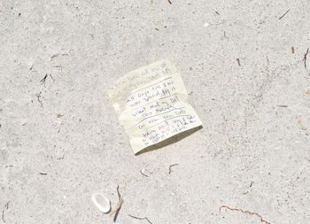High angle view of text on sand at beach
