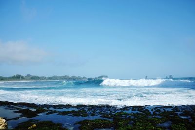 Scenic view of sea against blue sky