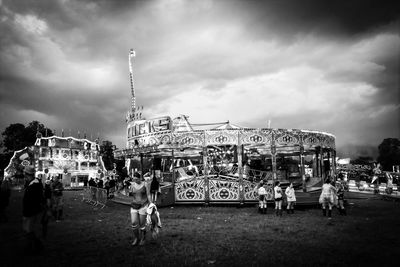 View of amusement park ride against cloudy sky