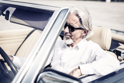 Midsection of man sitting in car