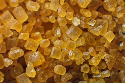 Extreme macro. sugar crystals. close-up of brown cane sugar on a plane. texture or background of