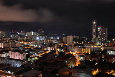 High angle view of illuminated buildings against sky at night