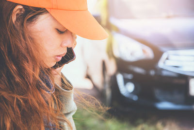 Side view of young woman talking over smart phone