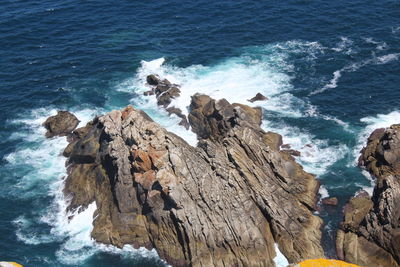 High angle view of rocks at sea shore