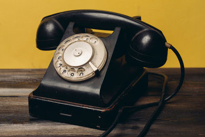 Close-up of telephone on table