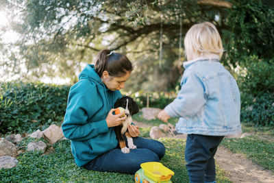 Side view of boy playing with toy on field