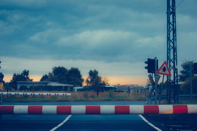 Road sign against sky