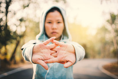 Portrait of young woman standing on road