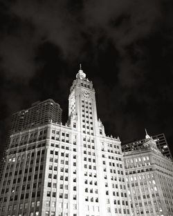 Low angle view of buildings against cloudy sky