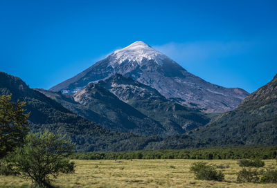 Scenic view of mountains against clear blue sky