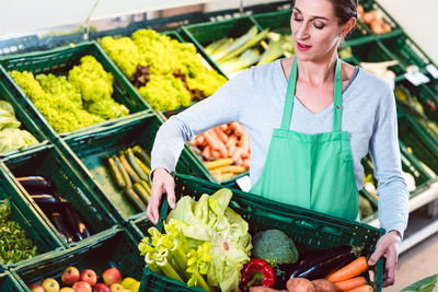 Midsection of woman standing at market stall
