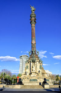 Low angle view of statue against blue sky