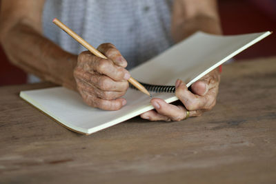 Close-up of man holding paper