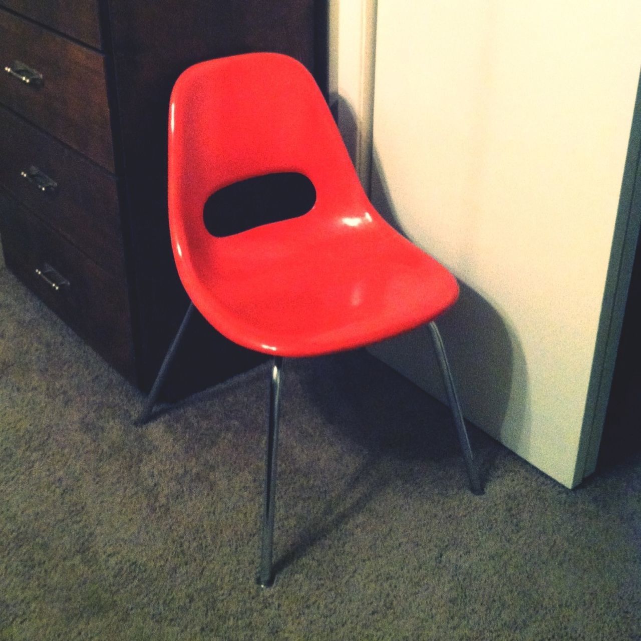 indoors, red, still life, close-up, high angle view, table, absence, no people, empty, single object, communication, chair, wall - building feature, home interior, metal, day, wall, connection, white color, seat