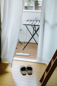 High angle view of slipper on hardwood floor at home