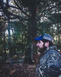 Side view of man against trees