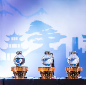 Close-up of glass against blue sky