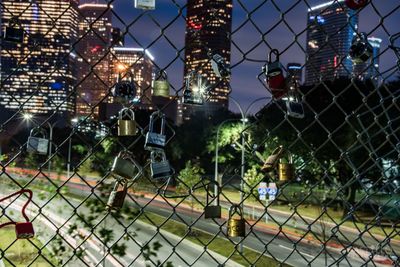 Close-up of illuminated chainlink fence against sky