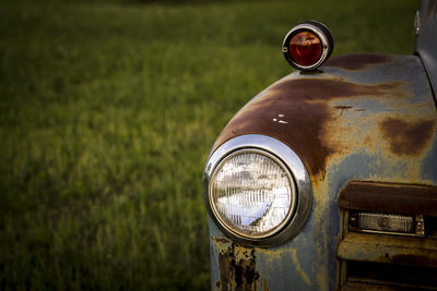 Close-up of headlight of abandoned car