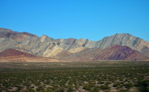 Scenic view of mountains against clear blue sky