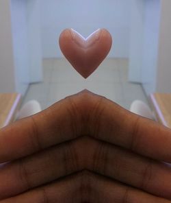 Close-up of hand holding heart shape