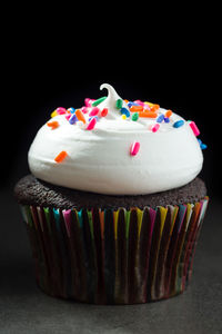 Close-up of cupcakes against black background