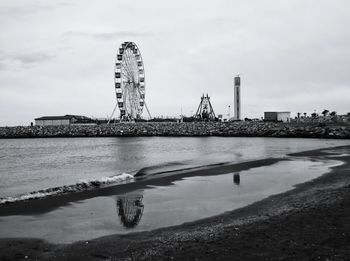 View of bridge over river against cloudy sky