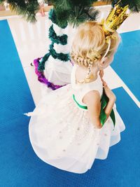 High angle view of cute girl sitting on floor