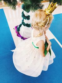 High angle view of cute girl wearing white dress at home