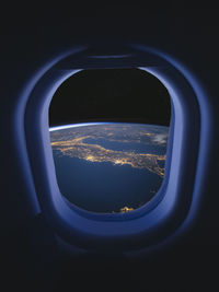 View sea and cityscape through airplane window