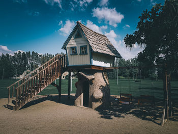 House by trees against sky