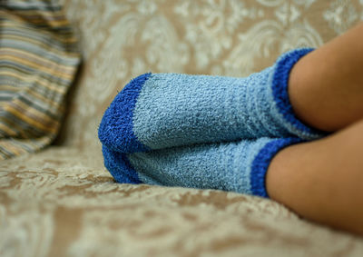 Close-up of child wearing blue socks