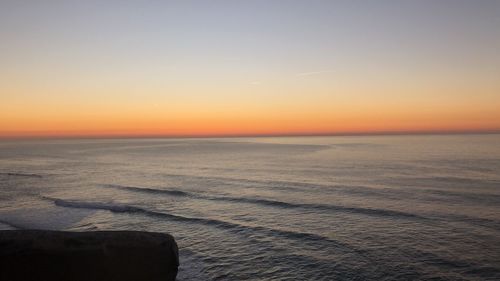 Scenic view of sea against clear sky during sunset