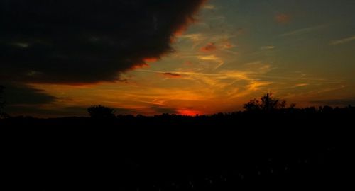 Silhouette of landscape against sky at sunset