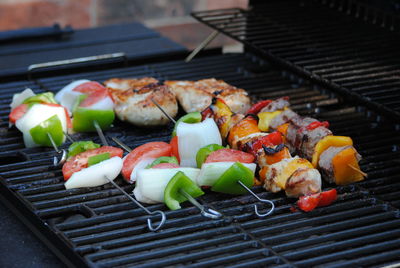 Close-up of food in skewers on barbecue grill