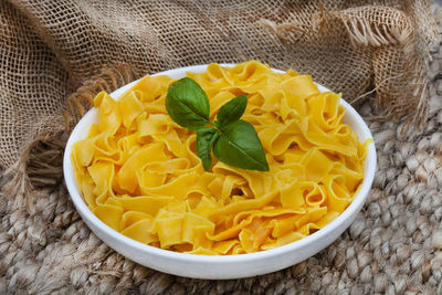 Bowl of cooked plain butternut pasta on rustic table