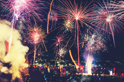 Low angle view of firework display at night