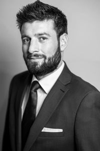 Portrait of bearded businessman against gray background