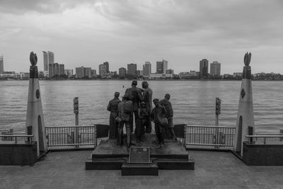 Statue in city at waterfront