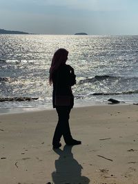 Side view of woman standing on beach